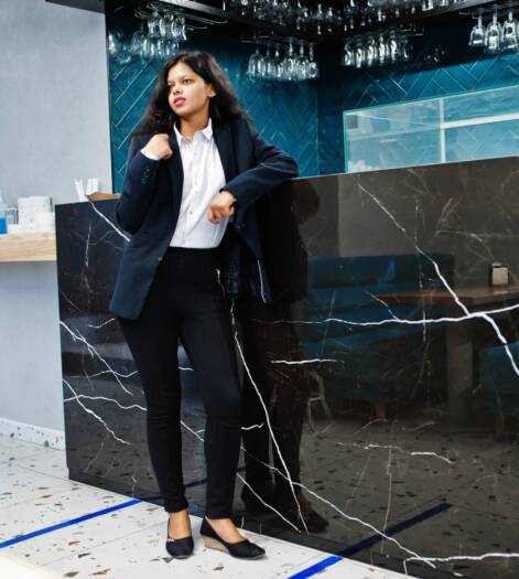 Gorgeous indian woman wear formal posing at cafe near bar counter.